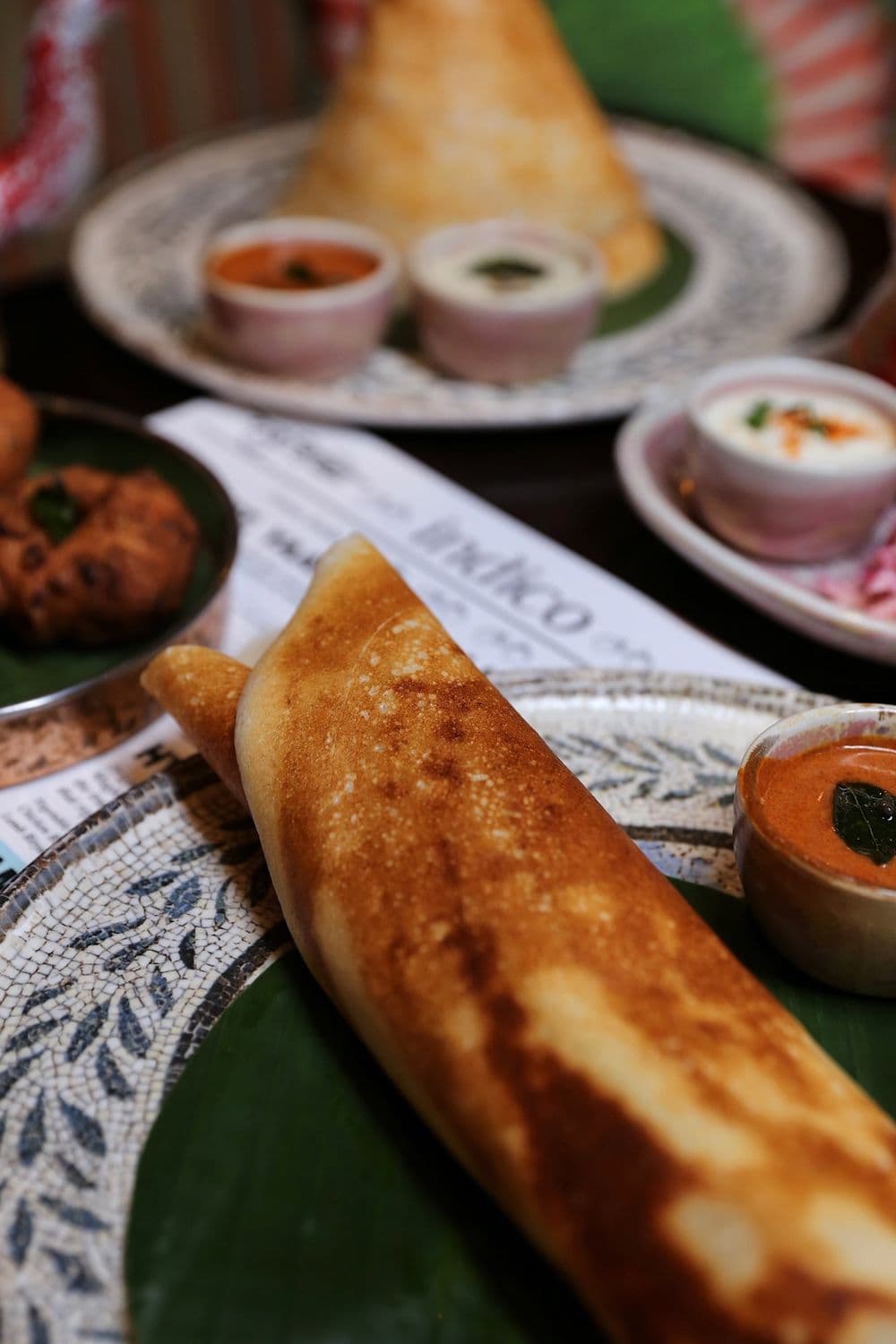 Tearing a dosa by hand